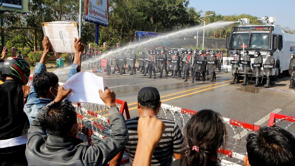 Police fire a water cannon at protesters rallying against the military coup and to demand the release of elected leader Aung San Suu Kyi, in Naypyitaw, Myanmar