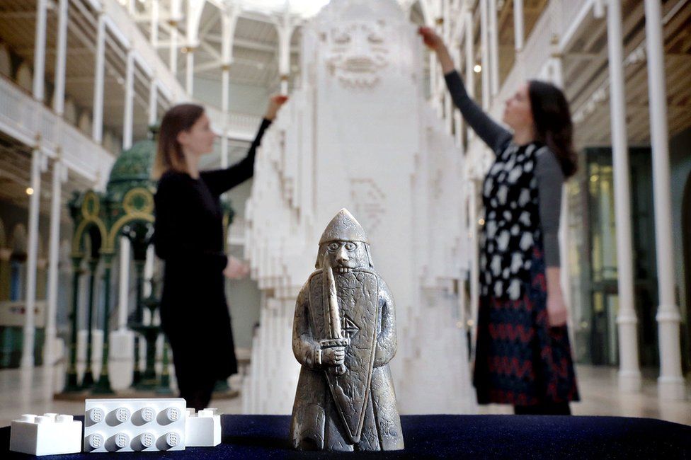 Lewis chessman and museum staff with Lego version