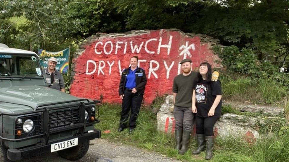 Elin Jones and other volunteers at the Cofiwch Dryweryn mural after it was restored