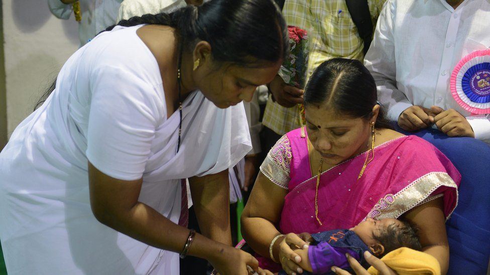 Nurse administers vaccine in Kerala