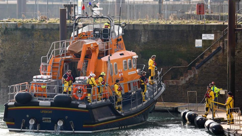 A lifeboat returns to the Port of Dover during the rescue operation to help the small boat