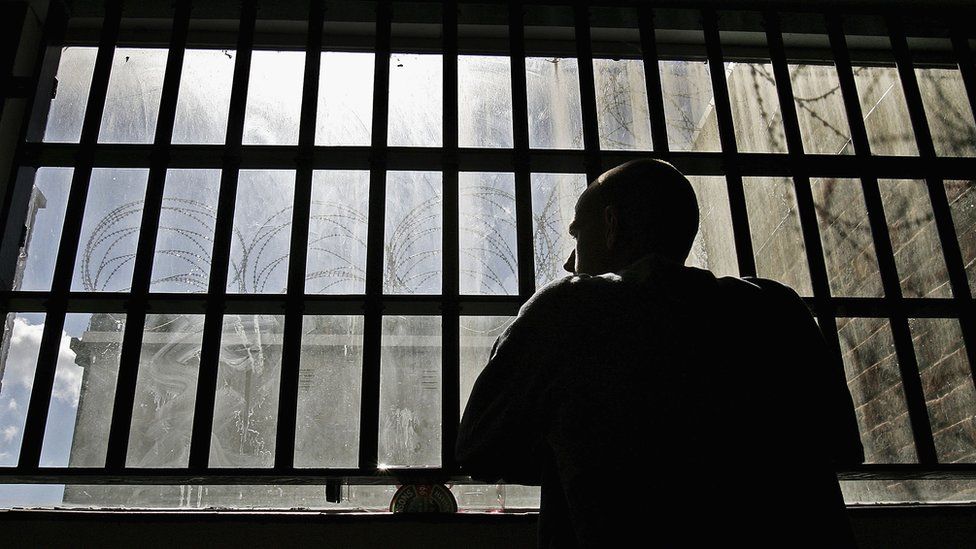 Prisoner in front of window