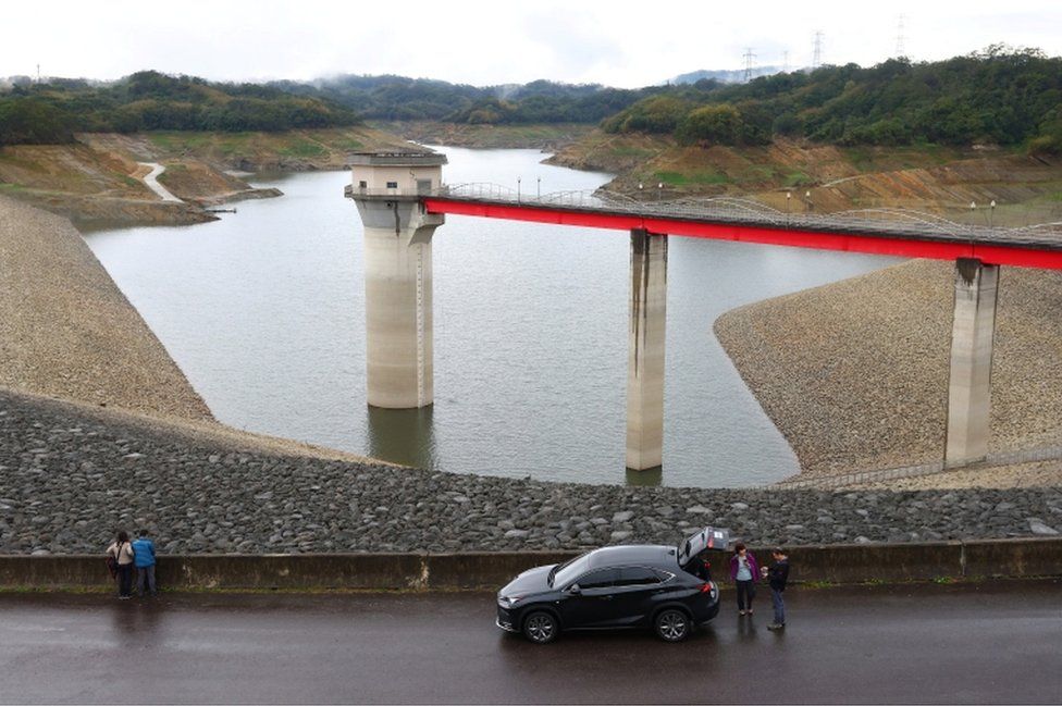 Tourists visit the Baoshan second reservoir amid low water levels during an island-wide drought, in Hsinchu, Taiwan, on March 6, 2021.