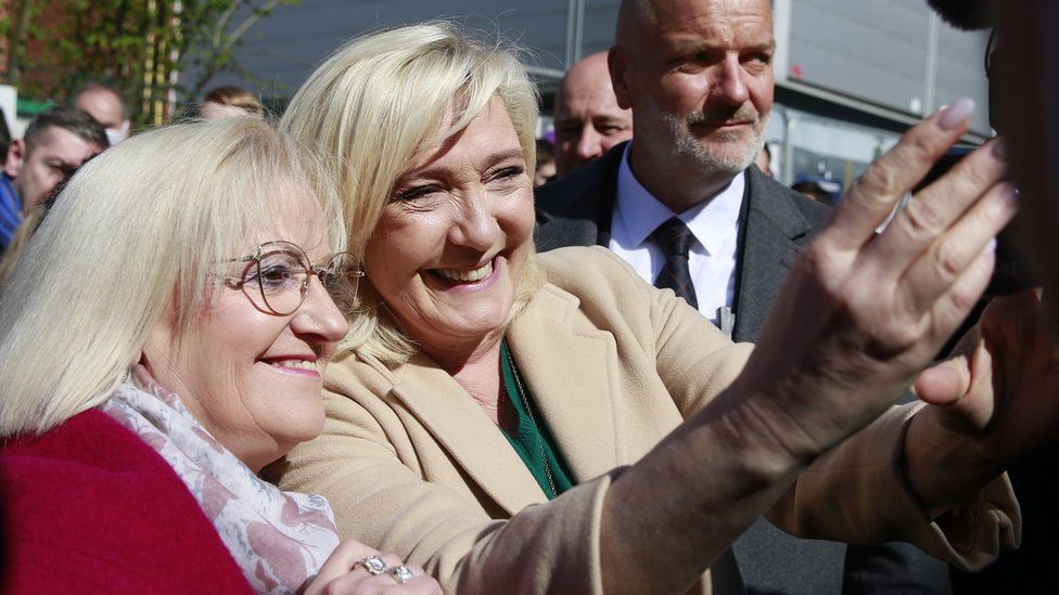 Marine Le Pen poses with supporters