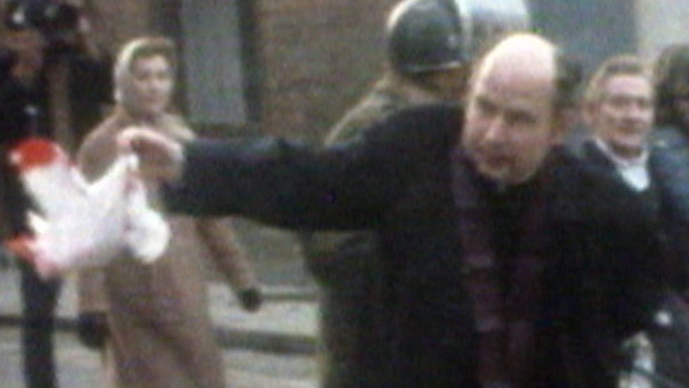 Fr Edward Daly waves a bloodied handkerchief in Londonderry on 30 January 1972