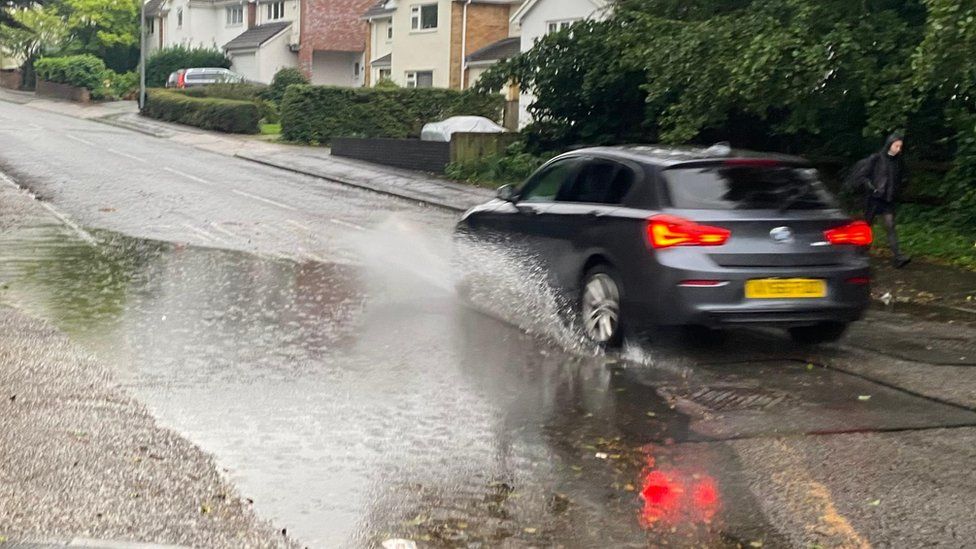 car drives through puddle