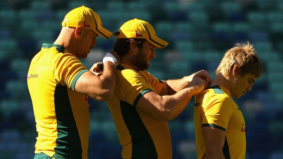 Australia's Wallabies rugby players fix tracking devices to each other