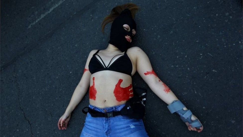 A demonstrator lies on the ground during a march demanding an end to sexism and gender violence in Santiago, Chile June 6, 2018