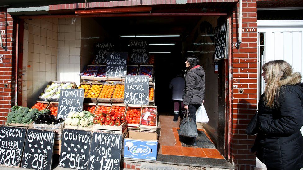 Customers wait in line outside a greengrocer's in Buenos Aires, Argentina August 14, 2019