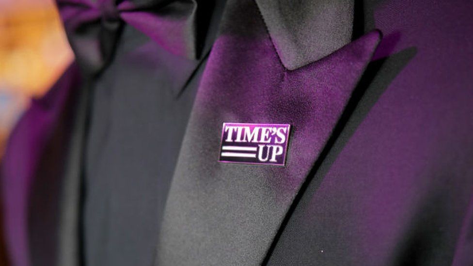 Joe Jonas wearing a Time's Up pin