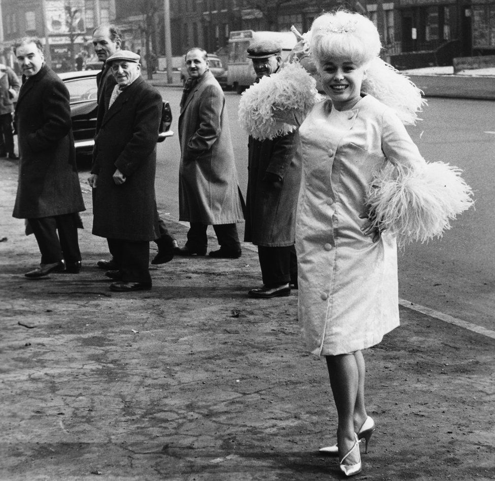 Attracting attention outside ABC Theatre in Mile End, east London, in 1963