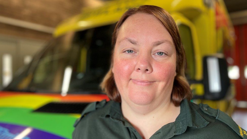 Joanna Paskell in uniform, stood in front of an ambulance