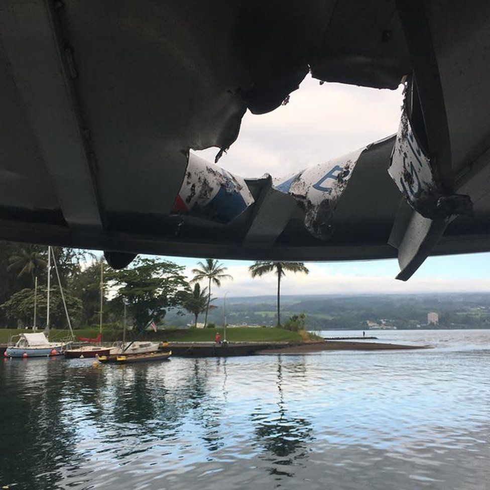 A hole in the roof of a tour boat after a lava explosion