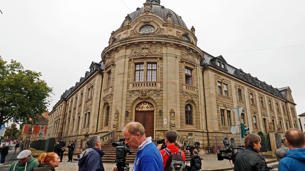 Journalists gather in front of the district court building, prior to the verdict in the trial of Abdul D in Landau, Germany.
