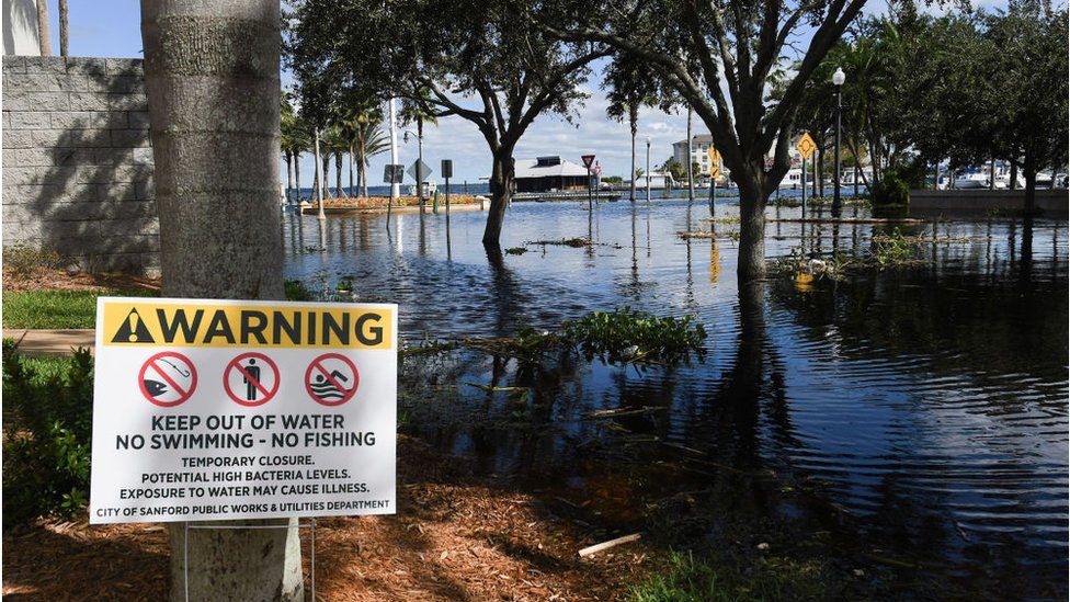 A warning sign near floodwaters