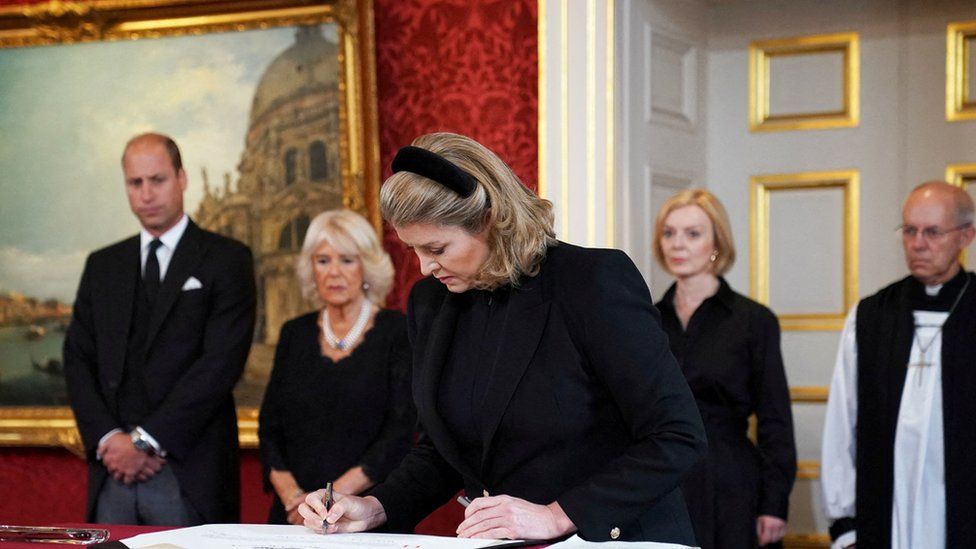 Penny Mordaunt signs the Proclamation of Accession of King Charles III watched by William, Prince of Wales, Camilla, the Queen Consort, Prime Minister Liz Truss, and the Archbishop of Canterbury
