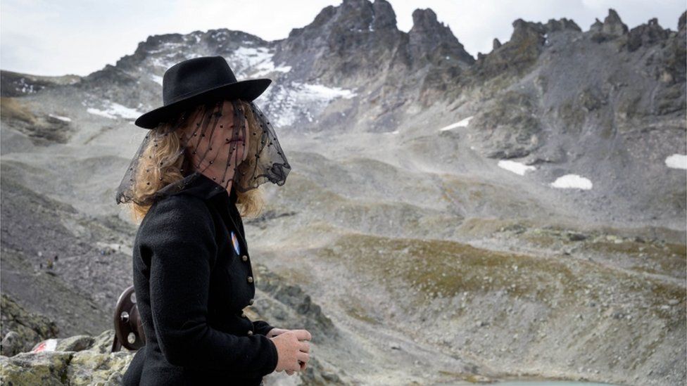 A woman takes part in a ceremony to mark the "death" of the Pizol glacier