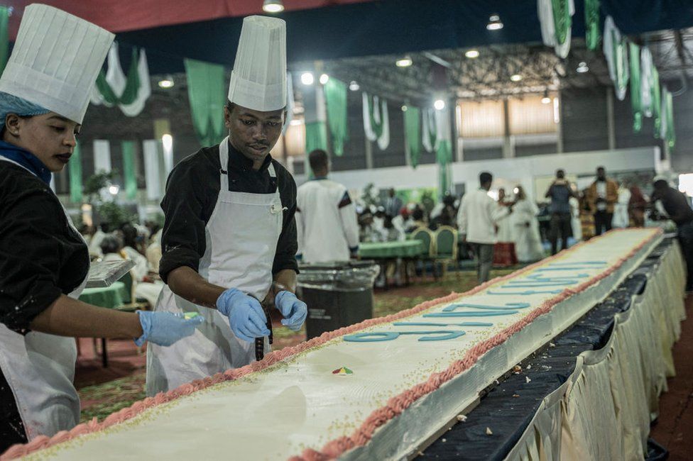 Chefs arranges a line of cake during a mass wedding called 'Yeshih Gabicha'.