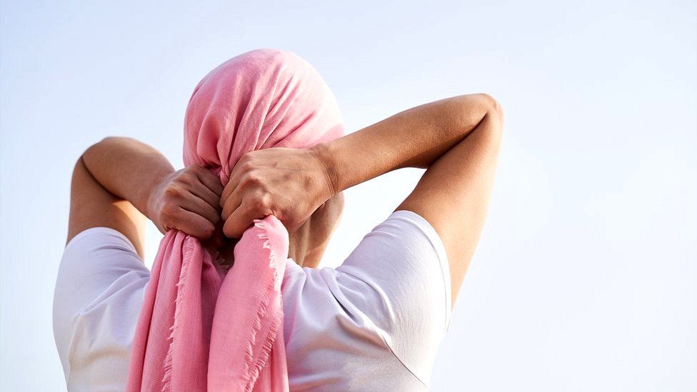 Woman tying a headscarf