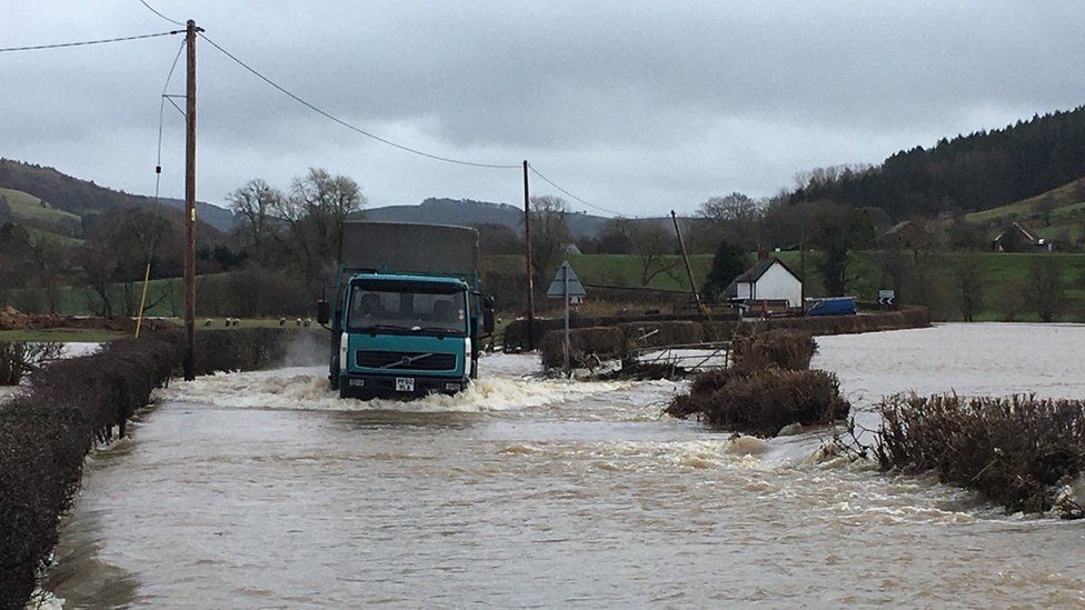 lorry driving through floodwater