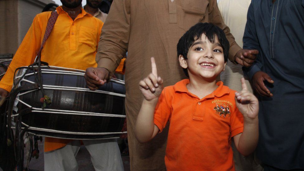 Jamal Uddin, 6, celebrates the release of his father Ali Haider Gilani in Lahore, Pakistan, Tuesday, May 10, 2016