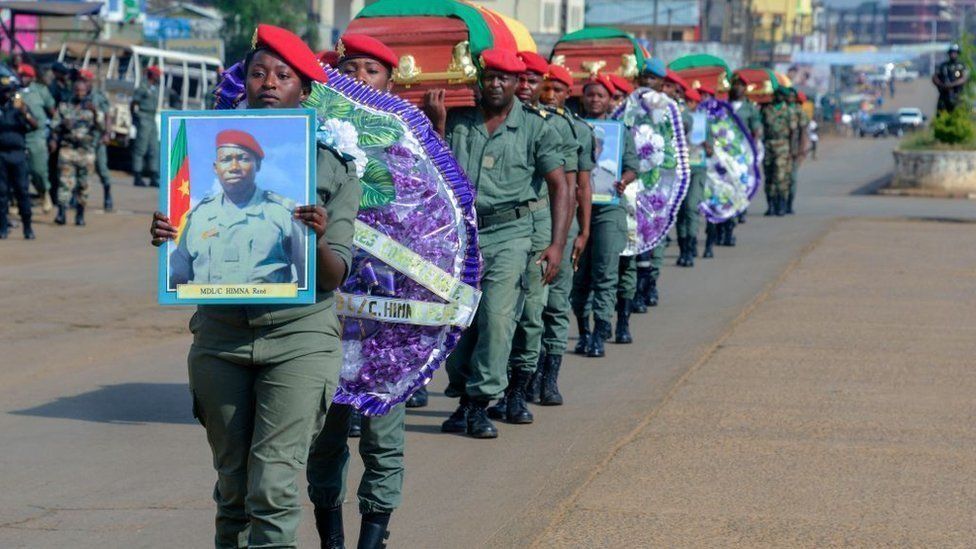 Soldiers carry the coffins of the four soldiers killed in the violence that erupted in the Northwest and Southwest Regions of Cameroon, where most of the country's English-speaking minority live, during a ceremony in Bamenda on November 17, 2017