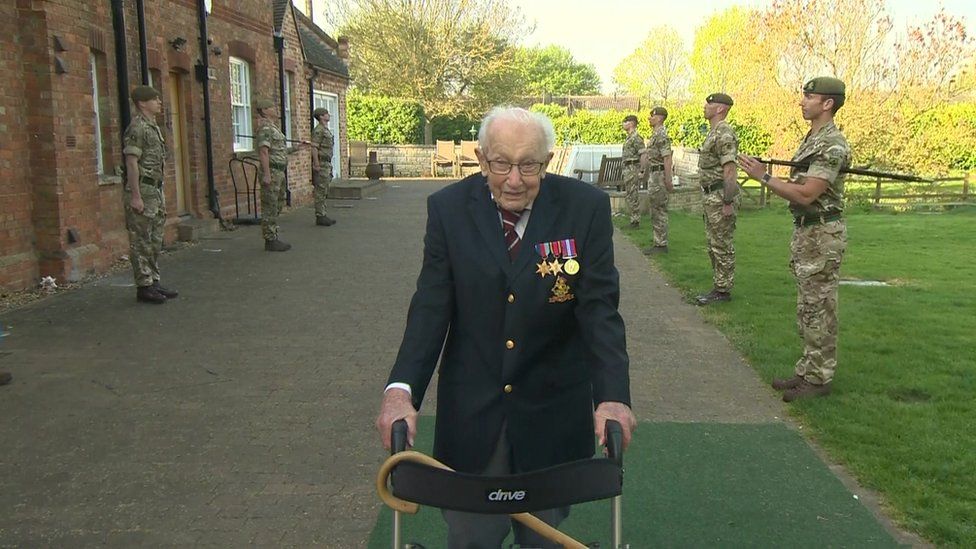 Captain Sir Tom Moore walking round his home