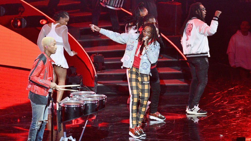 Pharrell performing with Migos