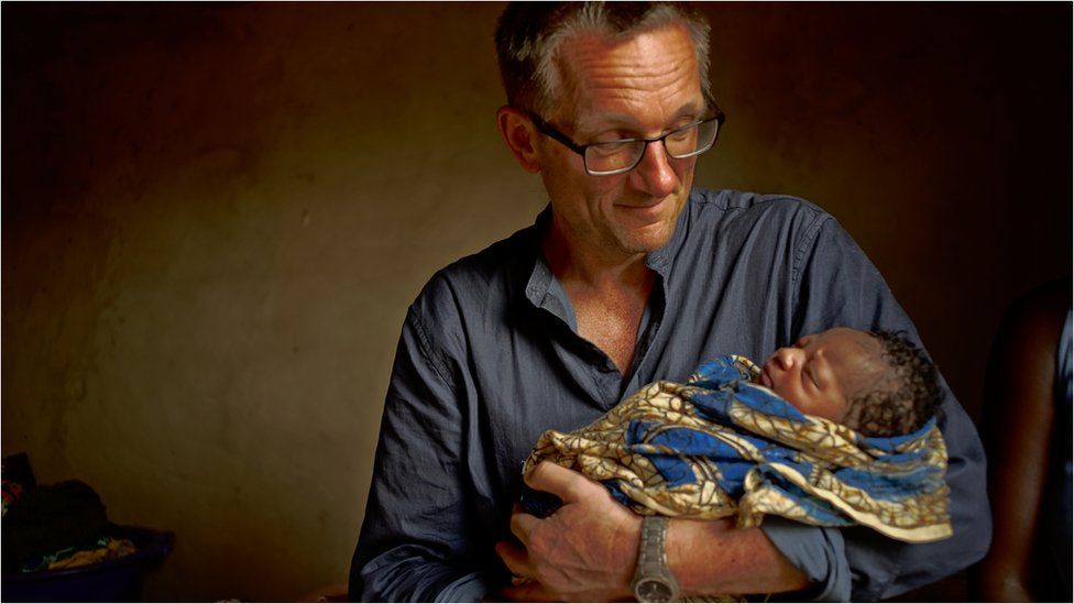 Michael Mosley holding newborn baby