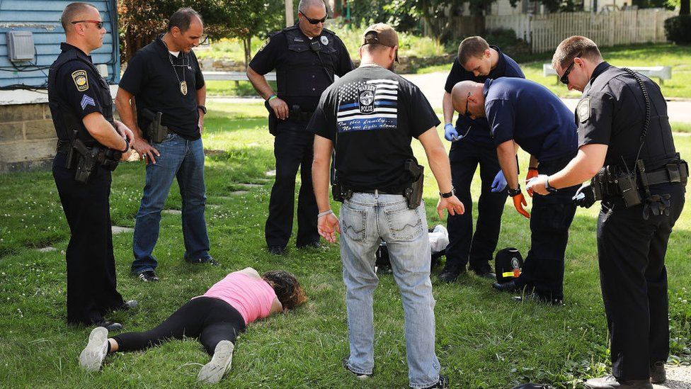 Woman who overdosed on heroin lying on the grass
