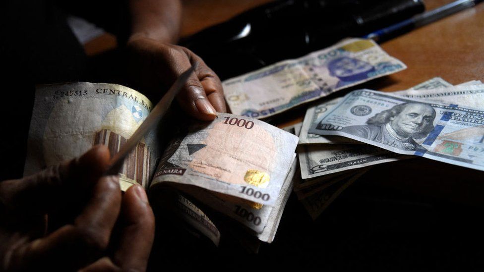 Man exchanges naira notes for dollars