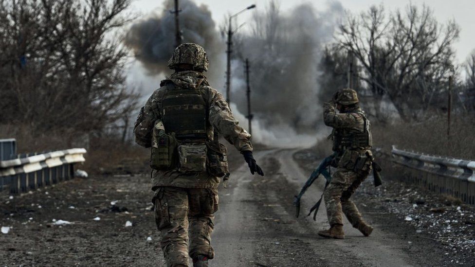 Ukrainian soldiers run in the Donbas region, February 2023