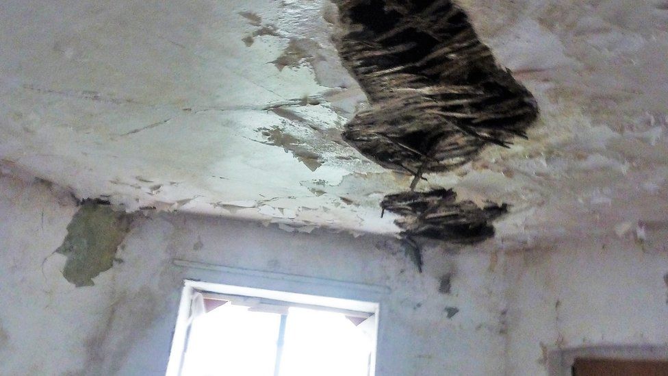 The damaged top floor ceiling