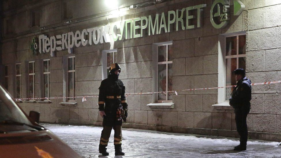 Police and emergency services arrive at a supermarket after an explosion in St Petersburg, Russia, 27 December 2017