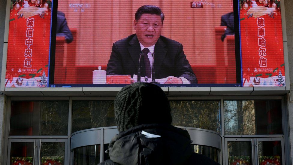 man stands and watches a large screen during President Xi Jinping"s speech at a grand gathering to celebrate the 40th anniversary of China"s reform and opening-up in Beijing on December 18, 2018 in Harbin, China