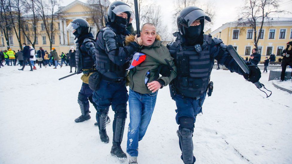 Police officers detain a protester in St. Petersburg