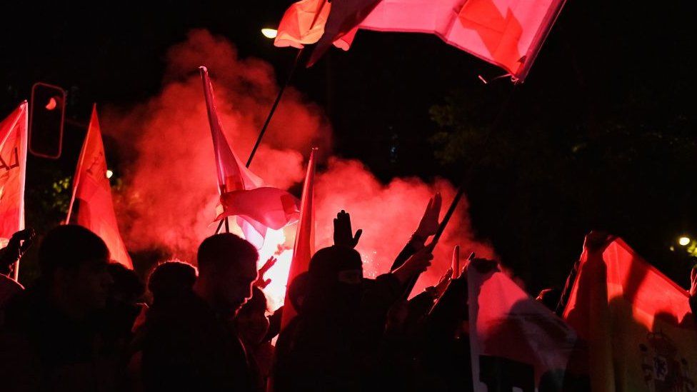 Thousands of protesters carrying flags and flares rallied outside Socialist party headquarters in Madrid on Tuesday night