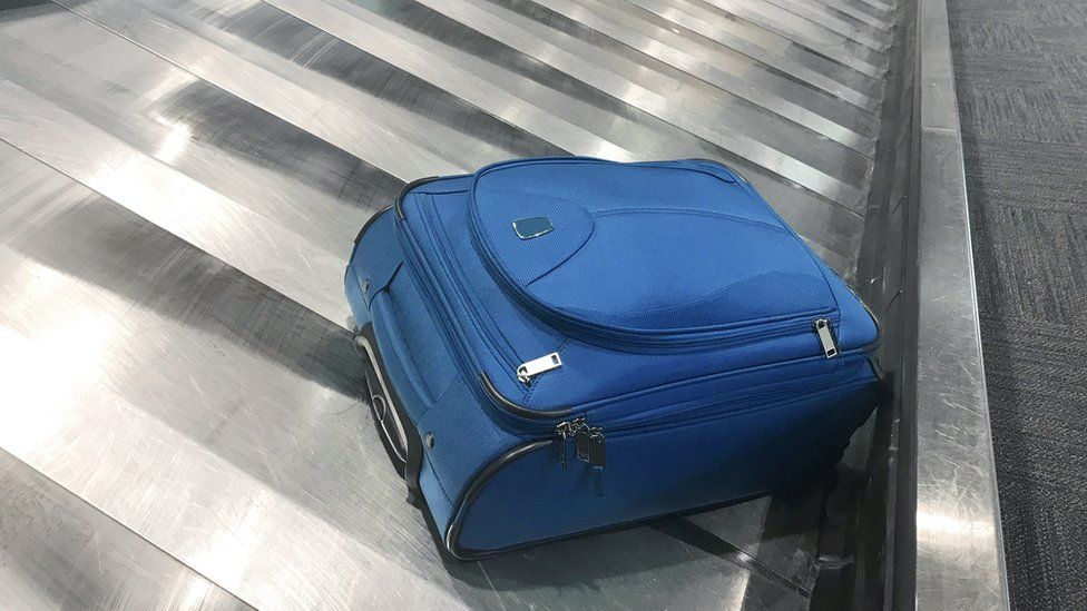 Blue case on luggage carousel