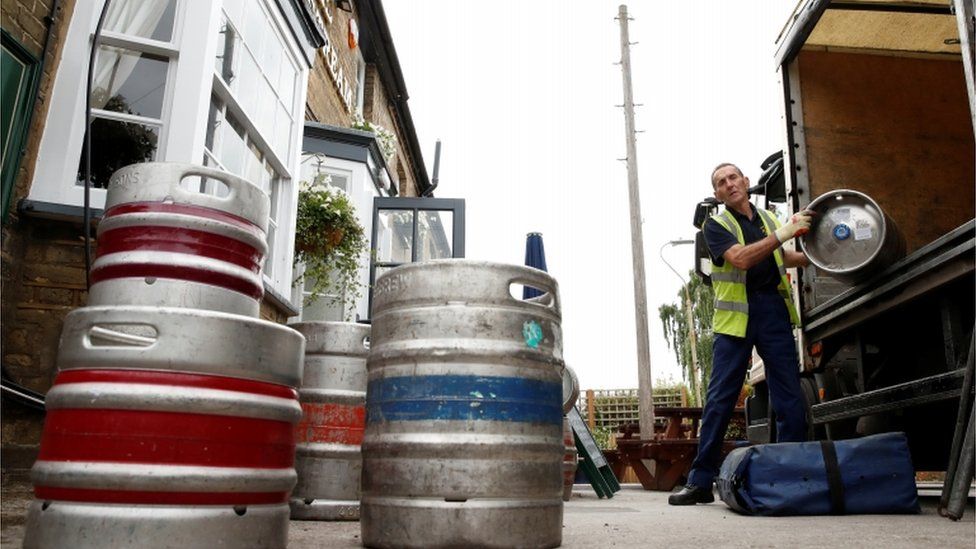 A man delivery barrels of beer