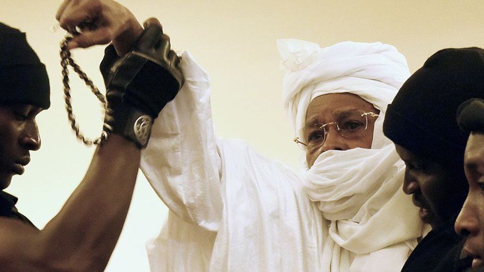 Former Chadian dictator Hissene Habre (C) is escorted by prison guards into the courtroom for the first proceedings of his trial by the Extraordinary African Chambers in Dakar on July 20, 2015.