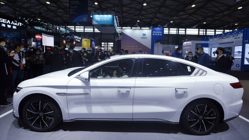Visitors look at a BYD electric car equipped with Huawei's HICAR system at the Huawei booth at Mobile World Congress 2021