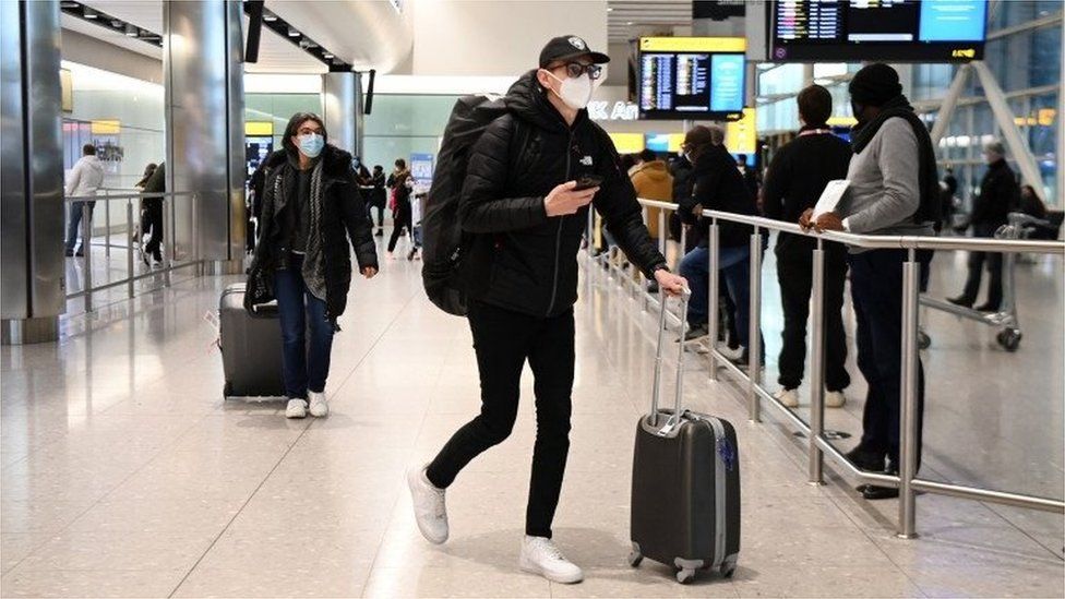 Travellers arrive at Heathrow Airport in London