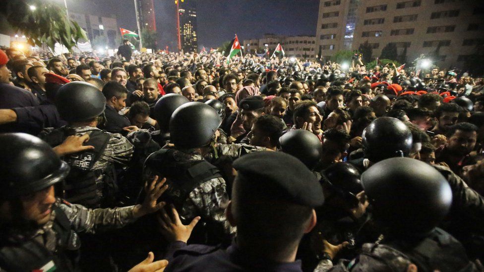 Anti-riot police clash with protesters outside the prime minister's office in Amman, Jordan, on June 4, 2018
