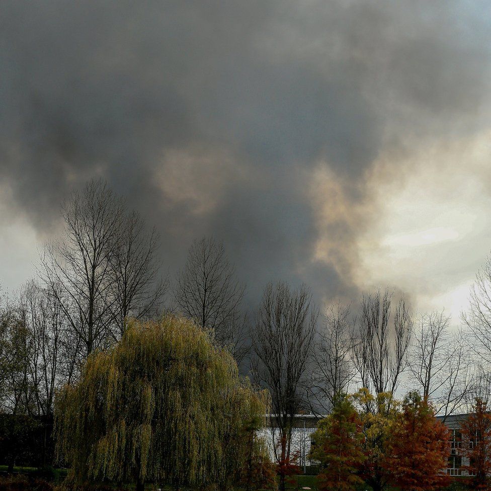Smoke billows from the Milcamps waffle factory in Forest in Brussels, Belgium, 23 November 2017