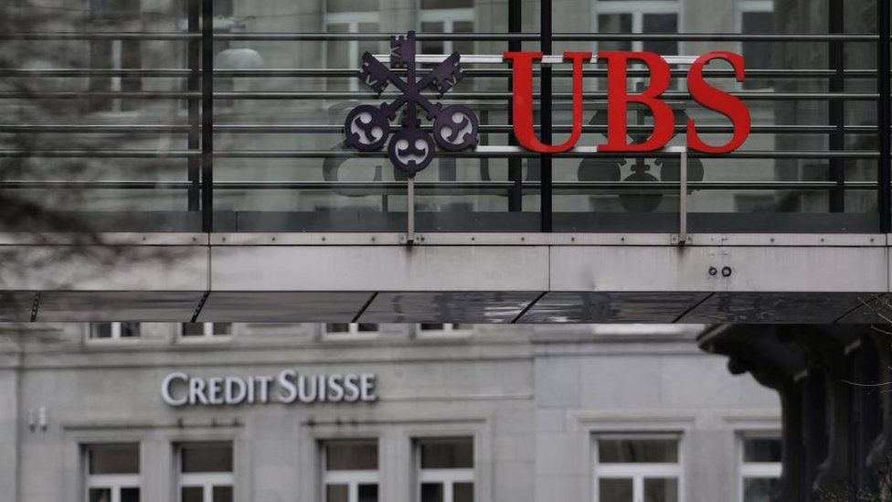 UBS and Credit Suisse logos on buildings in Zurich