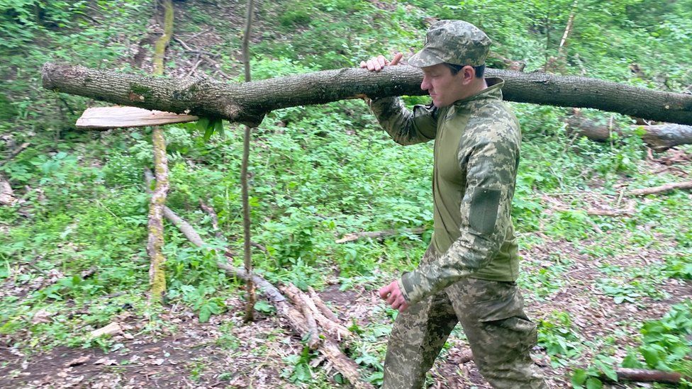 Soldier carrying log