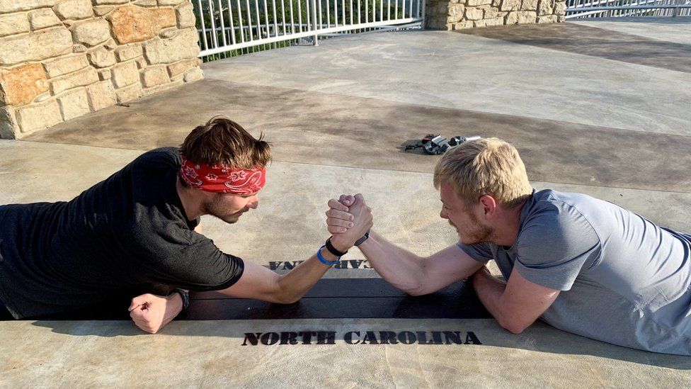 Patrick and Michael arm wrestling at Sassafras Mountain in South Carolina