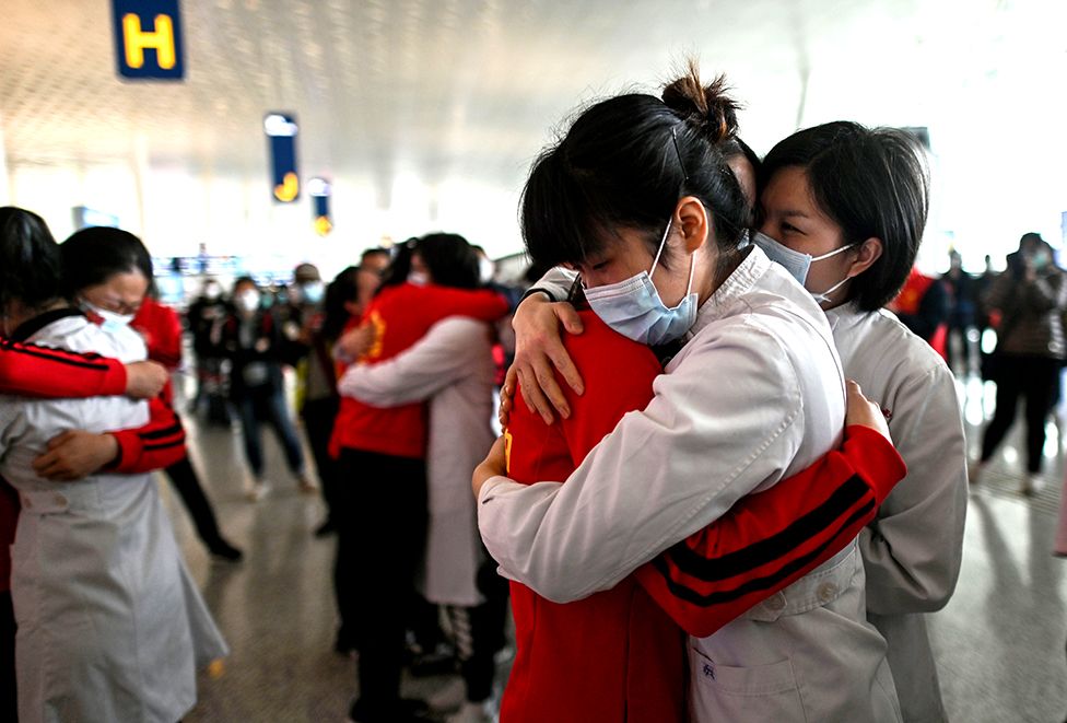 Medical staff hug nurses