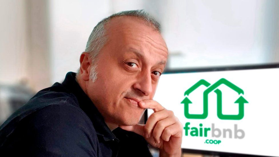 Emanuele Dal Carlo in front of computer with Fairbnb logo