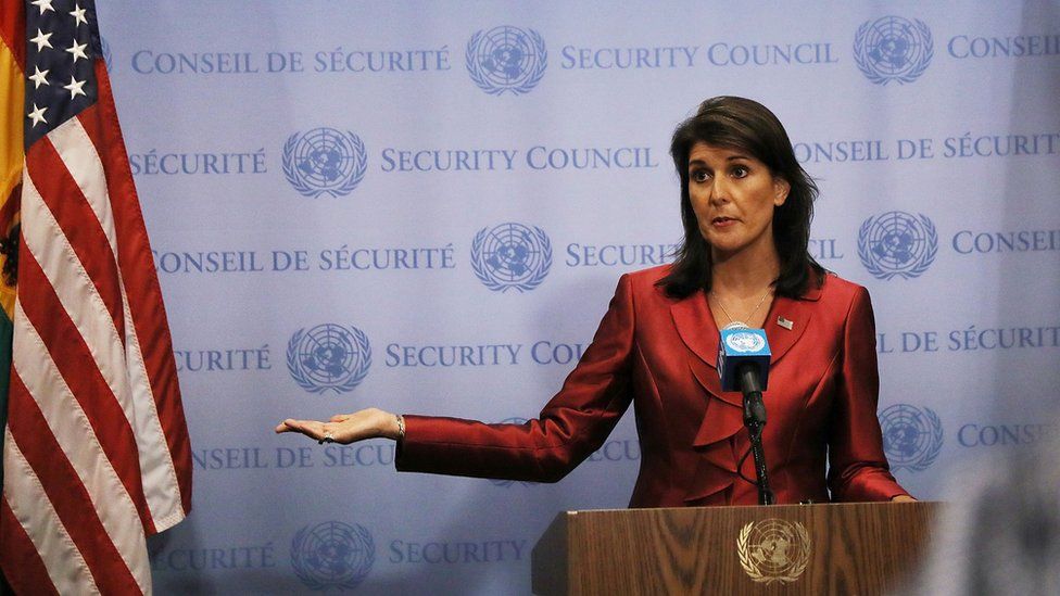 file image of Nikki Haley giving a speech, next to an American flag